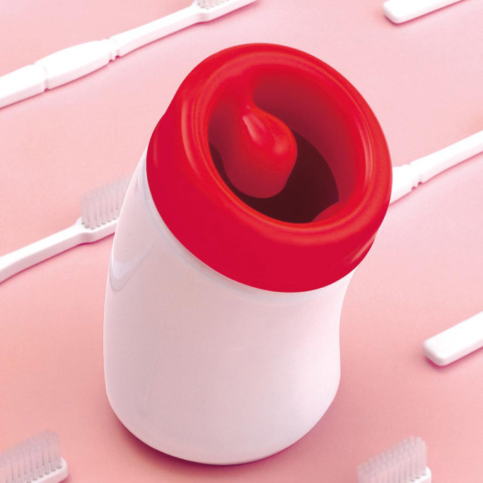 red and white ceramic and plastic tonsil toothbrush holder