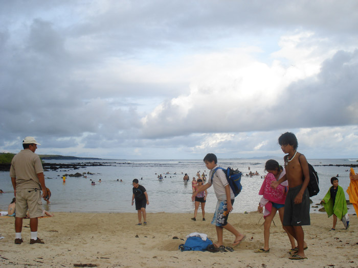 people at finch bay hotel beach galapagos