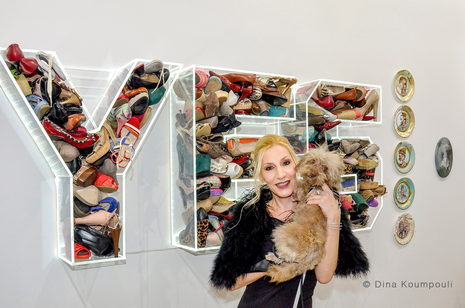 Alexandra Kollaros and her dog Kaya in front of Nar's plexiglass artwork "yes"