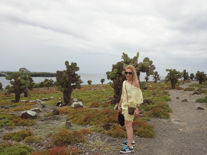 Alexandra Kollaros in front of cactus plants in galapagos