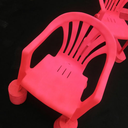 Red chairs on black floor at art athina 2019