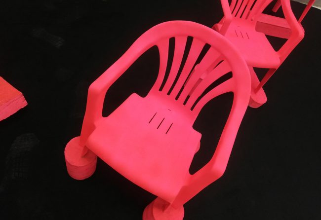 Red chairs on black floor at art athina 2019