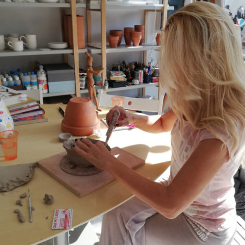 Alexandra creating a ceramic vessel