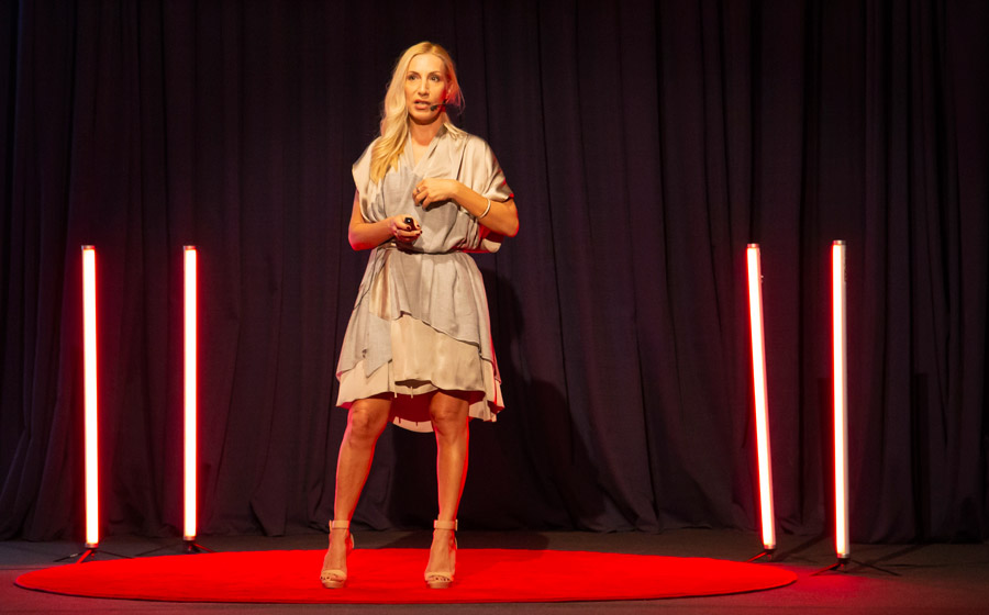 Alexandra Kollaros on stage delivering her Tedx Moraitis talk