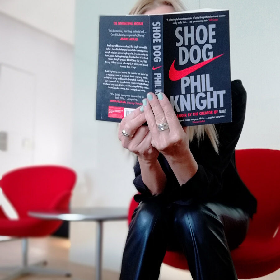 Alexandra Kollaros reading Shoe Dog book