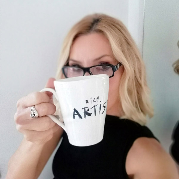 Blonde with white ceramic mug tagged Rich Artist